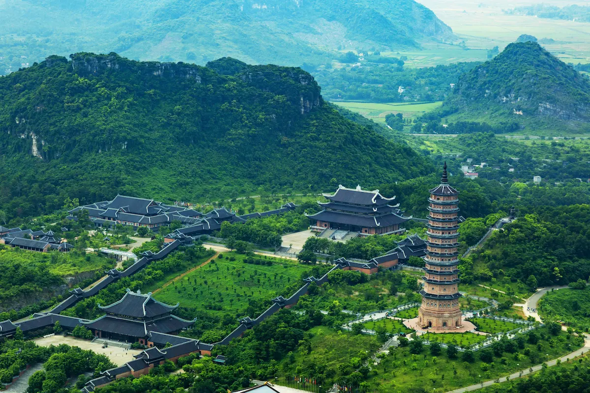Aerial view of Bai Dinh Pagoda surrounded by limestone mountains in Ninh Binh