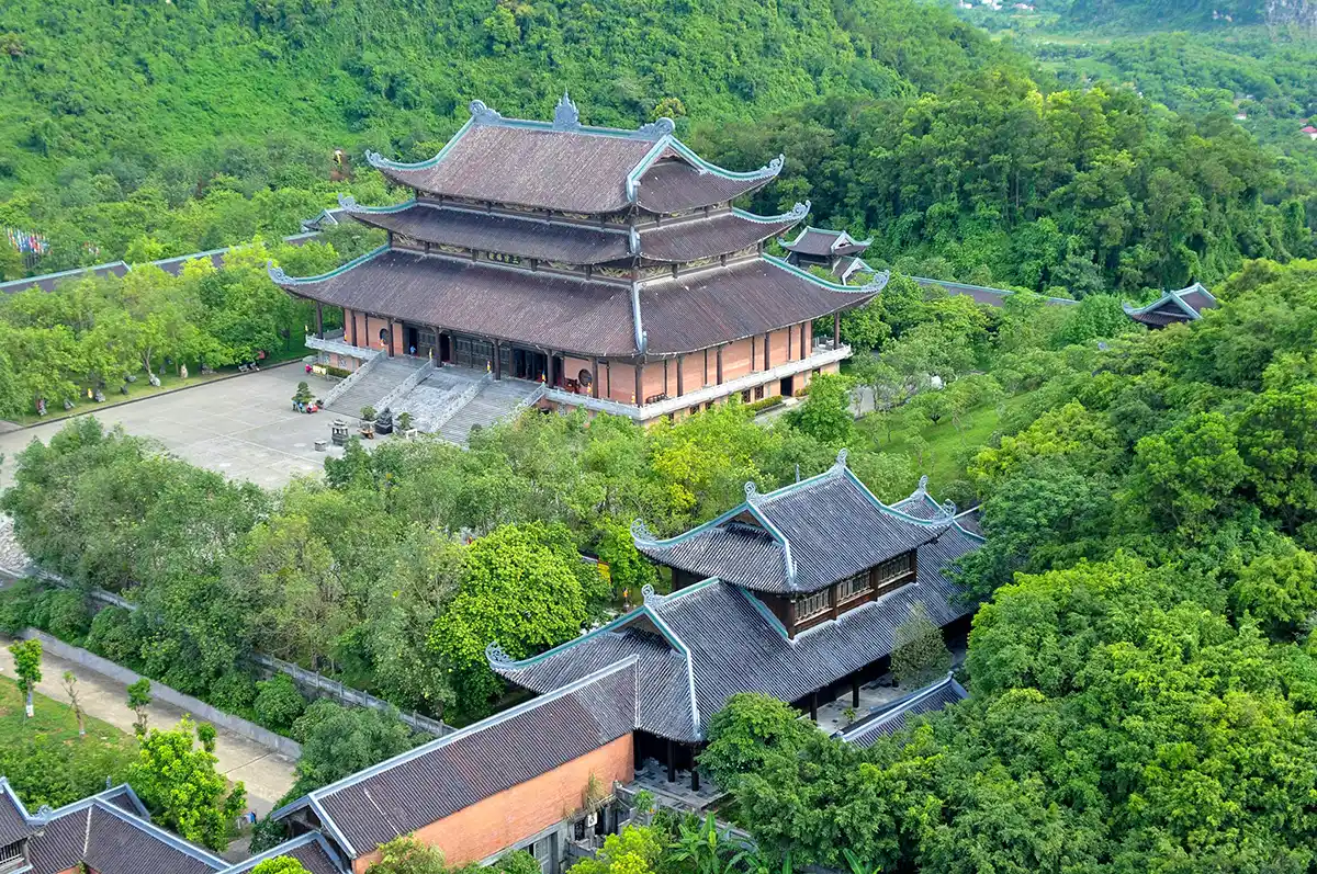 Aerial view of Bai Dinh Pagoda nestled among lush green mountains in Ninh Binh