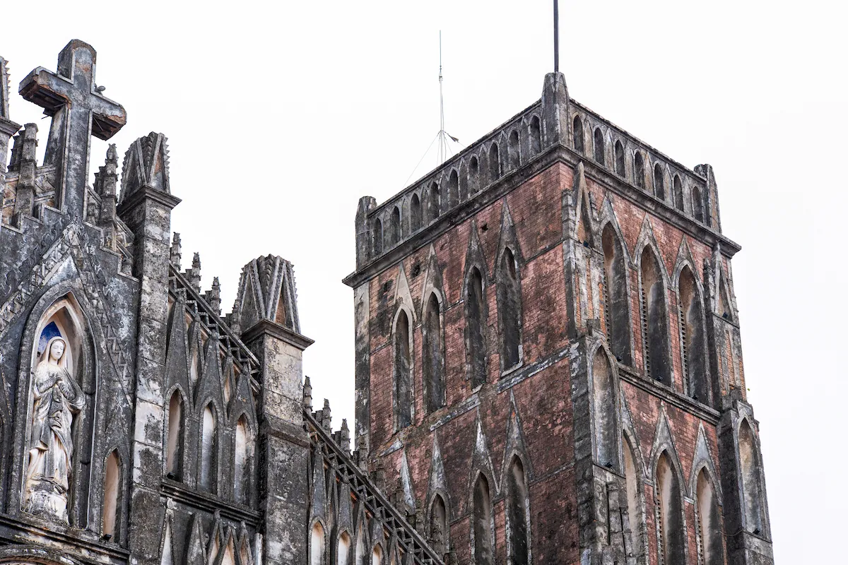 The Gothic bell tower and façade of So Kien Basilica in Ha Nam, Vietnam.