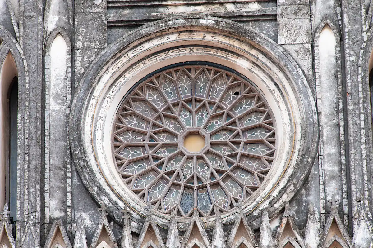The Gothic rose window on the façade of So Kien Basilica in Ha Nam, Vietnam.