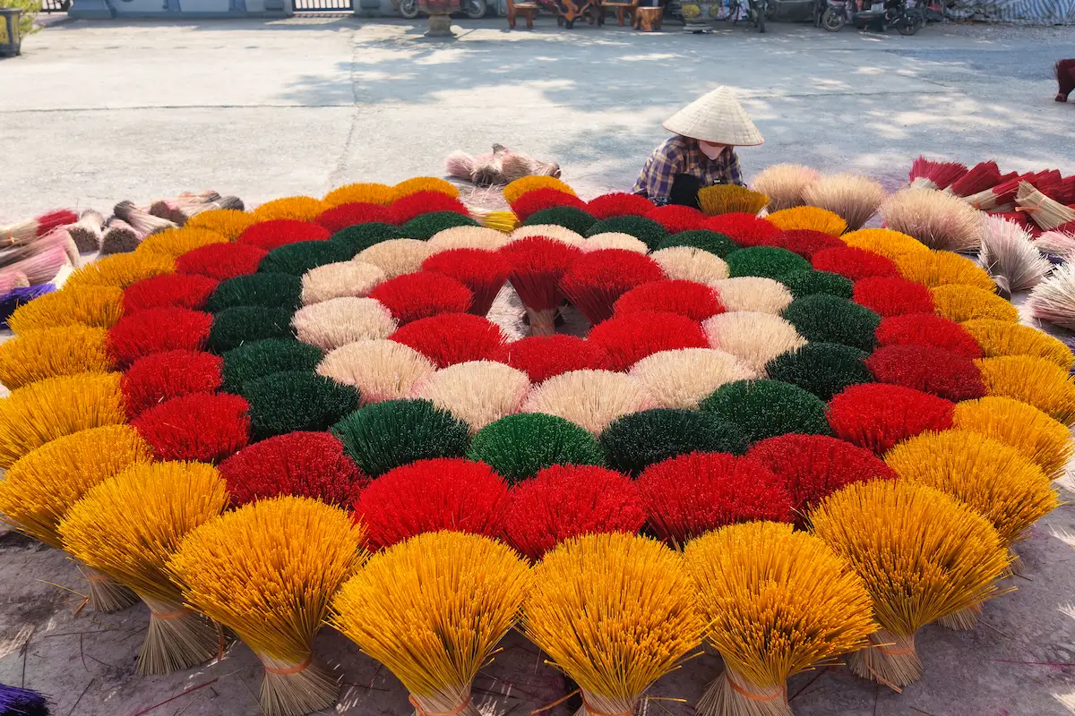 Colorful incense bundles arranged in a circular pattern at Quang Phu Cau