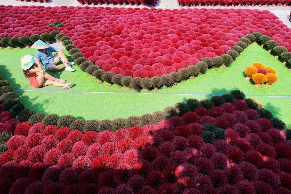 Top-down view of colorful incense bundles arranged at Quang Phu Cau village