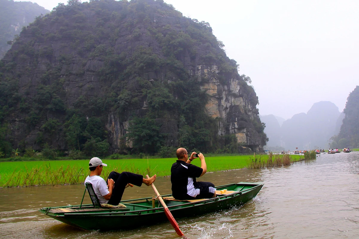 Boat ride through Tam Coc rice fields in Ninh Binh, Vietnam