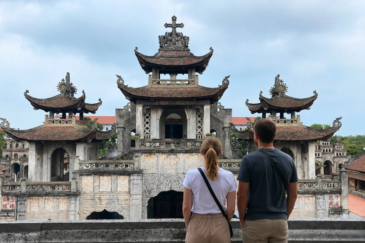 Two foreign travelers admire Phat Diem Cathedral from behind.
