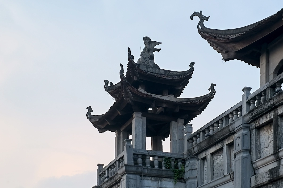 Low-angle view of curved Vietnamese roofs at Phat Diem Cathedral