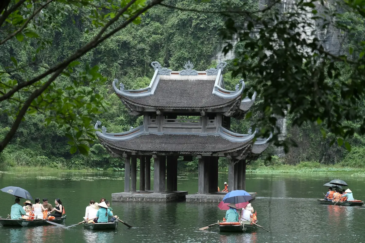 Trang An boat tour through scenic waterways and limestone mountains in Ninh Binh