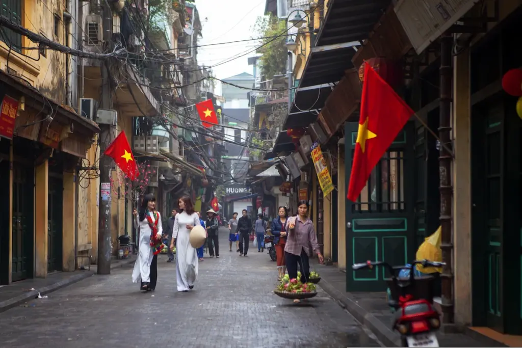Traditional streets and Vietnamese flags during a Hanoi walking tour