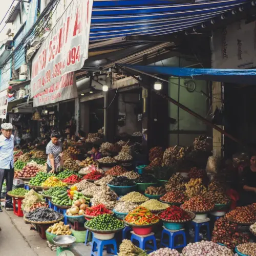Fresh vegetables and spices displayed at a bustling Hanoi market