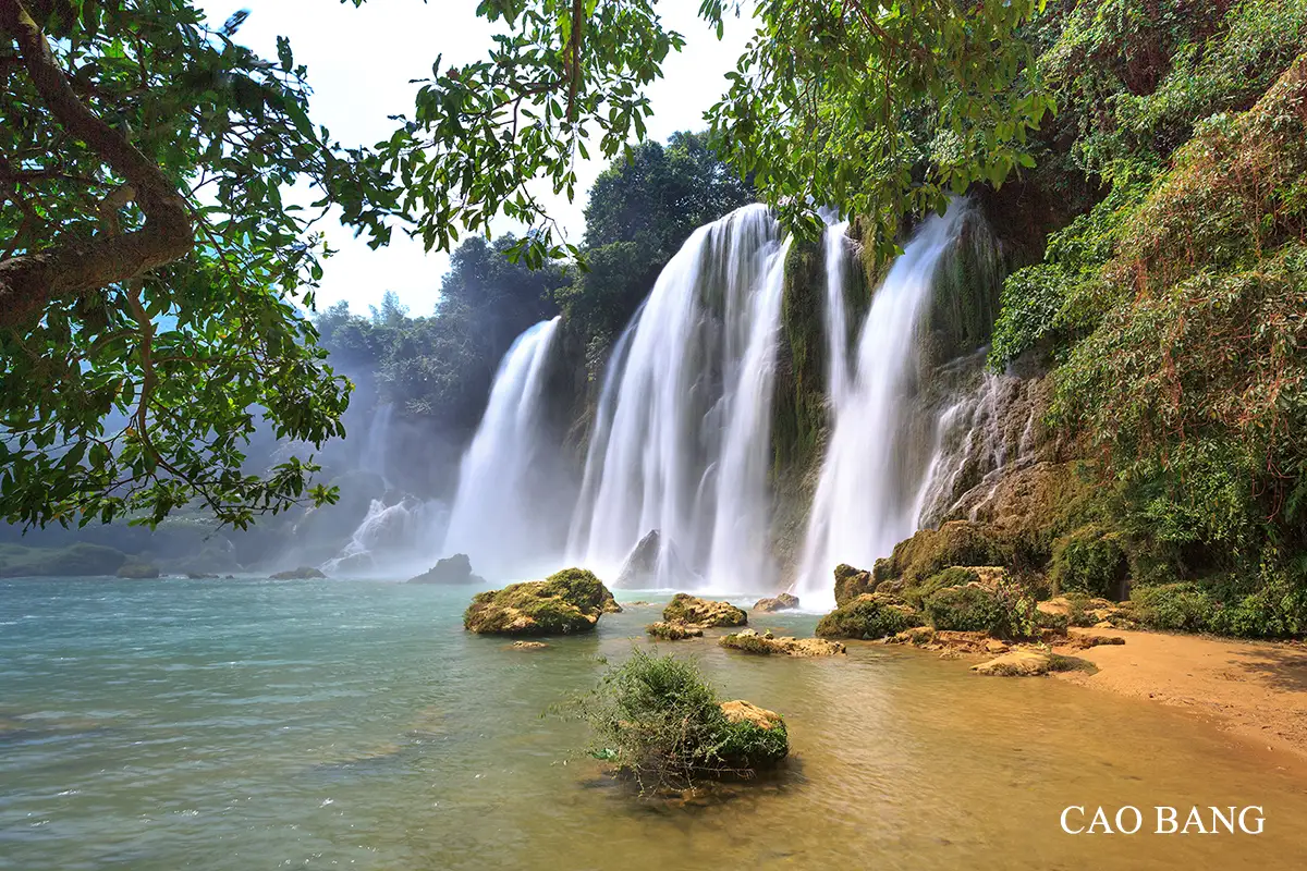 Ban Gioc Waterfall surrounded by lush mountains in Cao Bang