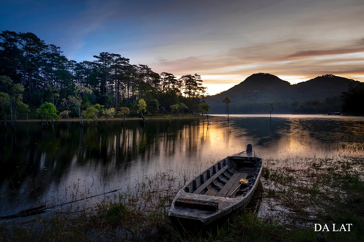 Da Lat mountain lake surrounded by pine forests at sunset