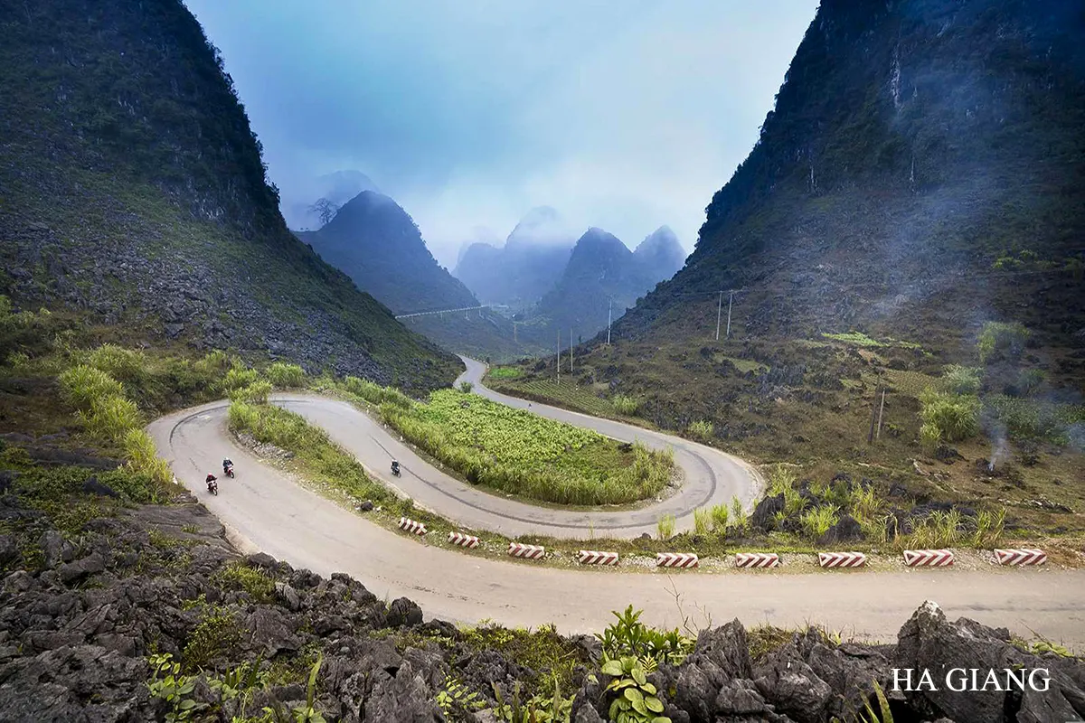 Ha Giang mountain road winding through limestone valleys