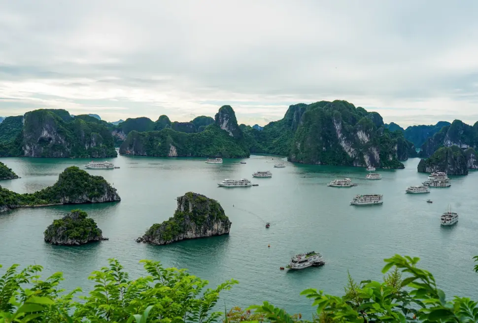 Ha Long Bay cruise boats among limestone islands and emerald waters