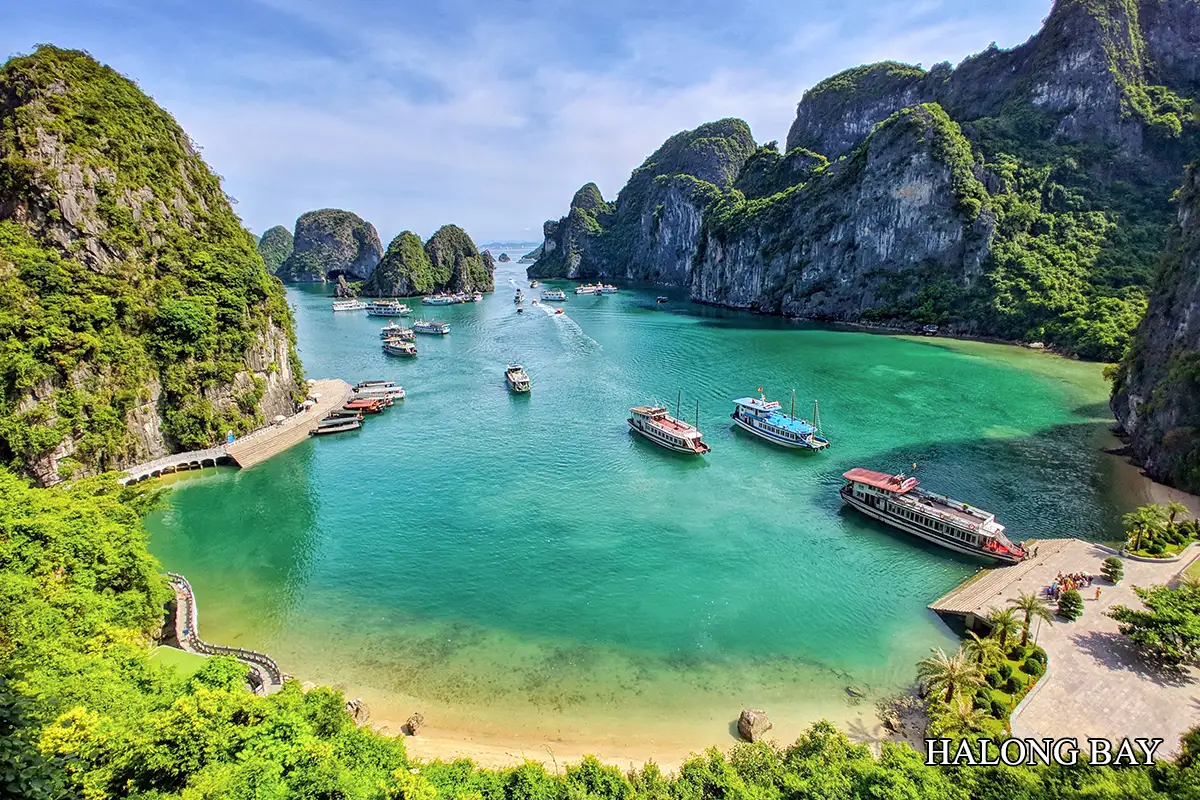 Ha Long Bay limestone islands and traditional cruise boats
