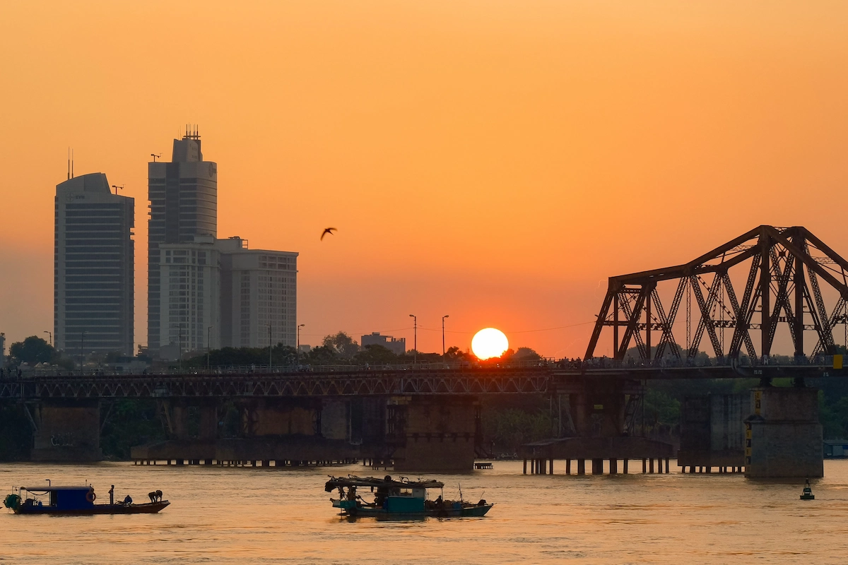 Sunset view over Long Bien Bridge and the Red River in Hanoi