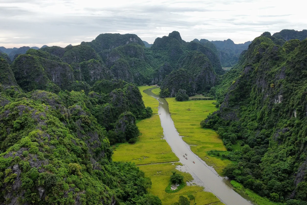 Ninh Binh travel guide featuring Tam Coc River and lush limestone karsts